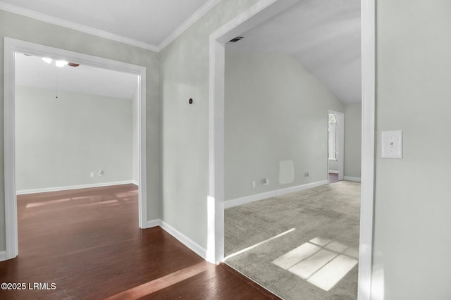 unfurnished room with crown molding, dark wood-style flooring, lofted ceiling, and baseboards