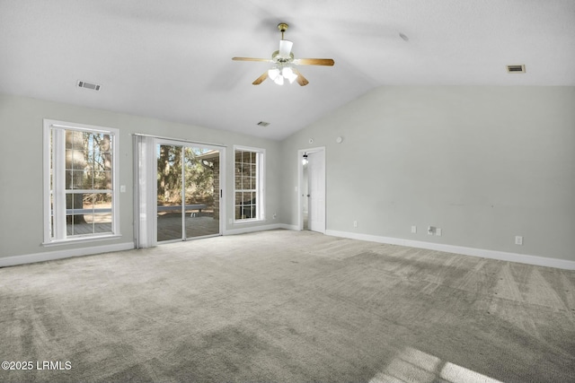 unfurnished living room featuring baseboards, visible vents, lofted ceiling, ceiling fan, and carpet flooring