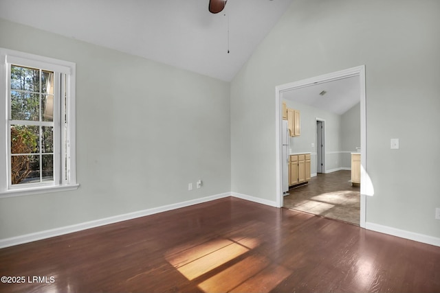 unfurnished room with a ceiling fan, dark wood-style flooring, high vaulted ceiling, and baseboards