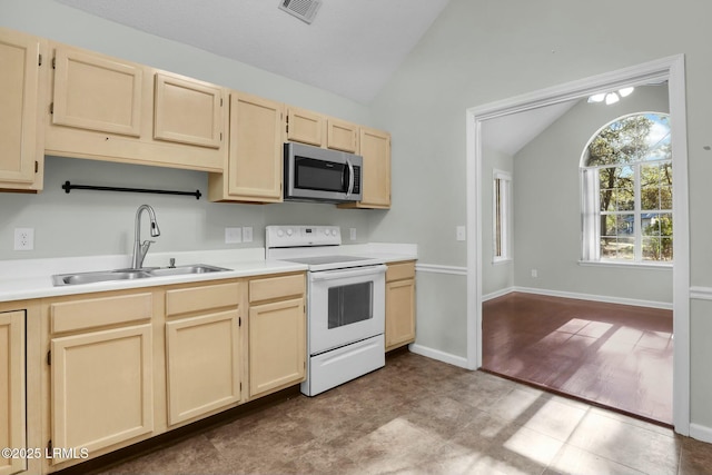 kitchen with white electric stove, stainless steel microwave, light countertops, and a sink