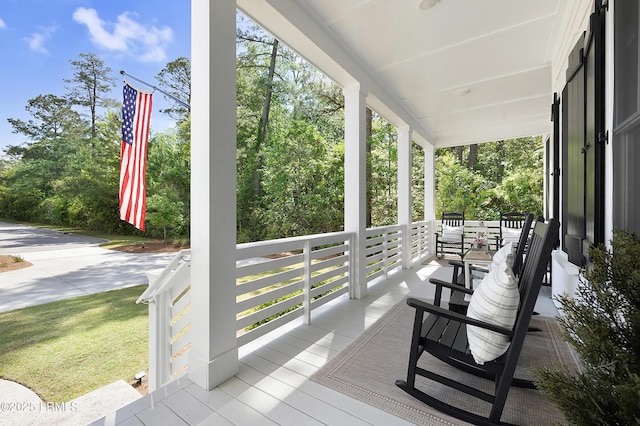 wooden terrace featuring covered porch