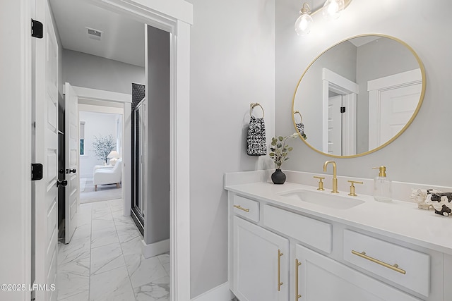 bathroom with baseboards, marble finish floor, visible vents, and vanity
