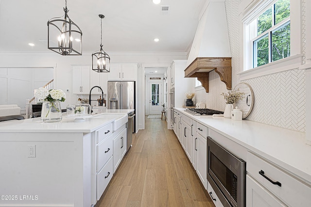kitchen with custom exhaust hood, recessed lighting, light countertops, white cabinetry, and stainless steel appliances