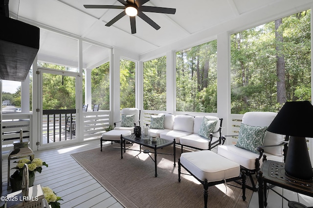 sunroom / solarium with a ceiling fan and an outdoor hangout area