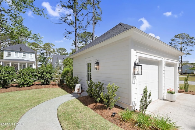 view of home's exterior featuring a lawn, driveway, and roof with shingles