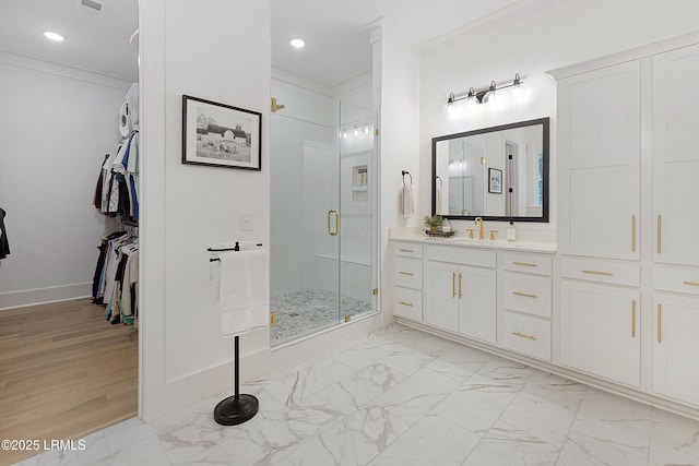 full bath with vanity, ornamental molding, marble finish floor, and a shower stall