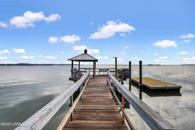 view of dock with a water view and a gazebo