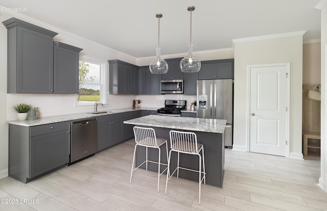 1118 Salty Hammock Ct, Beaufort, SC 29902 - kitchen with stainless steel appliances, wood tiled floors, a breakfast bar area, a kitchen island, and ornamental molding