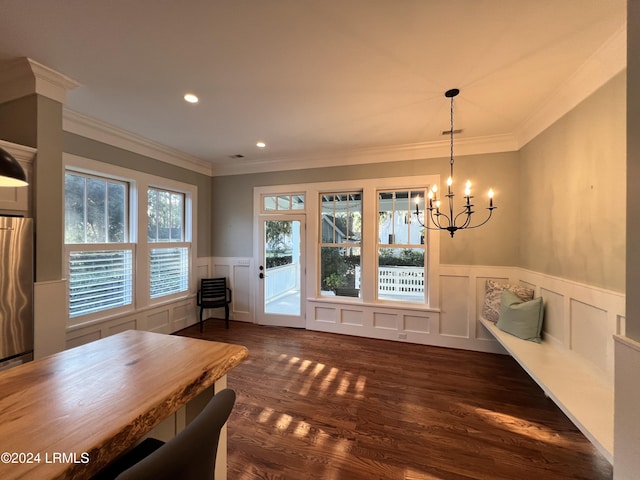 unfurnished dining area with crown molding, dark wood-type flooring, and a chandelier