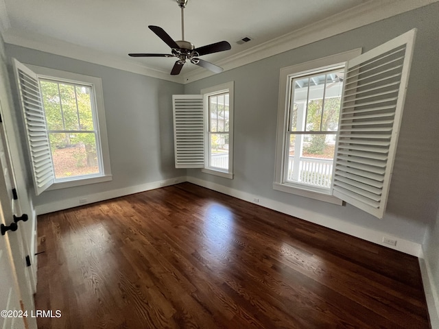 unfurnished room featuring dark hardwood / wood-style flooring, crown molding, and a healthy amount of sunlight