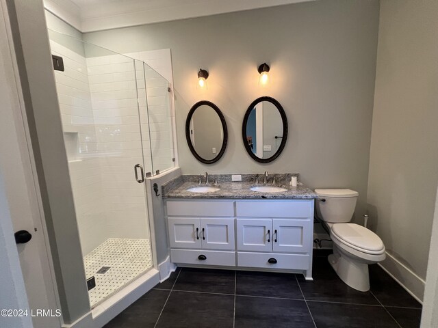 bathroom featuring vanity, toilet, tile patterned floors, and walk in shower