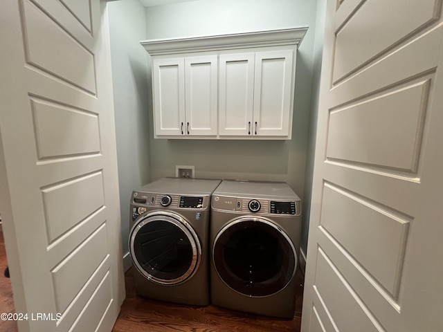 washroom featuring cabinets, dark hardwood / wood-style floors, and separate washer and dryer