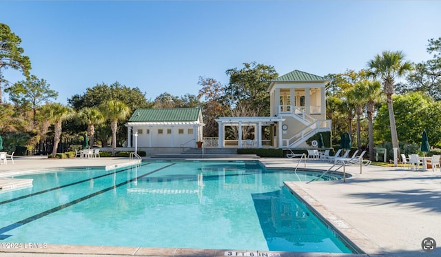 view of pool with a patio and a pergola