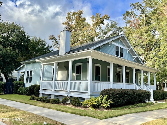 view of side of home with a porch