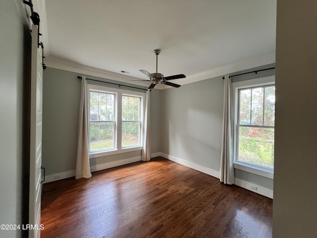 unfurnished room with dark wood-type flooring, ceiling fan, and ornamental molding