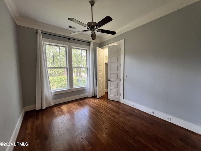 unfurnished bedroom with ornamental molding, dark hardwood / wood-style floors, and ceiling fan