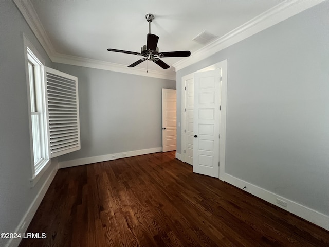 unfurnished bedroom featuring ceiling fan, ornamental molding, dark hardwood / wood-style floors, and multiple windows