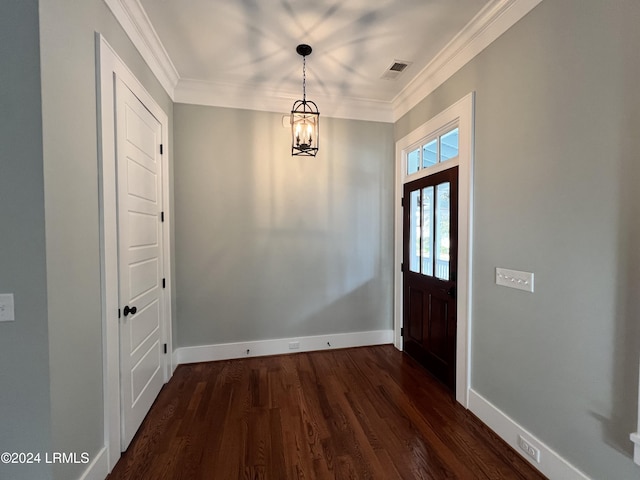 foyer with crown molding, dark hardwood / wood-style floors, and a notable chandelier