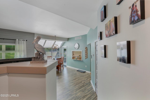 kitchen with hardwood / wood-style flooring and vaulted ceiling