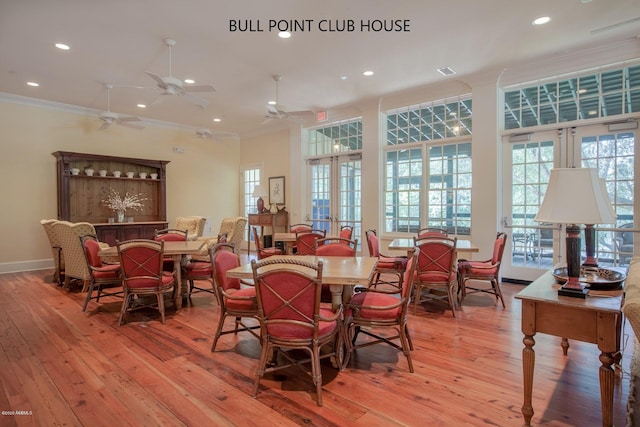 dining room featuring crown molding, light hardwood / wood-style flooring, and french doors