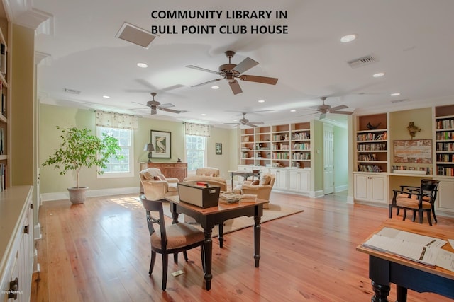 dining area featuring ornamental molding, built in features, and light hardwood / wood-style flooring