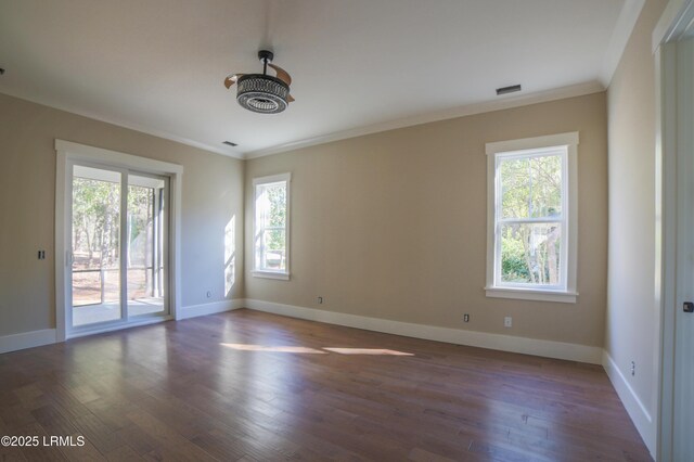 unfurnished room featuring crown molding and dark wood-type flooring