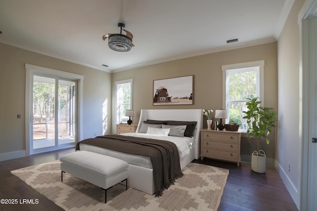 bedroom with dark wood-type flooring, crown molding, and access to outside