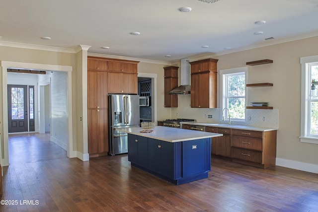 kitchen featuring wall chimney range hood, backsplash, stainless steel appliances, a center island, and dark hardwood / wood-style flooring