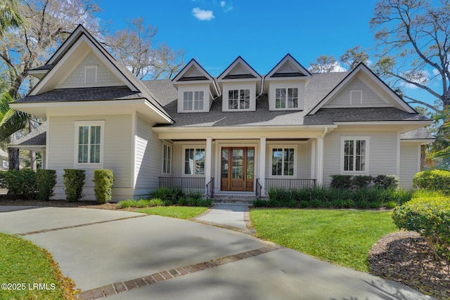 18 Baynard Cove Rd, Hilton Head Island, SC 29928 - view of front facade featuring covered porch, roof with shingles, and a front yard