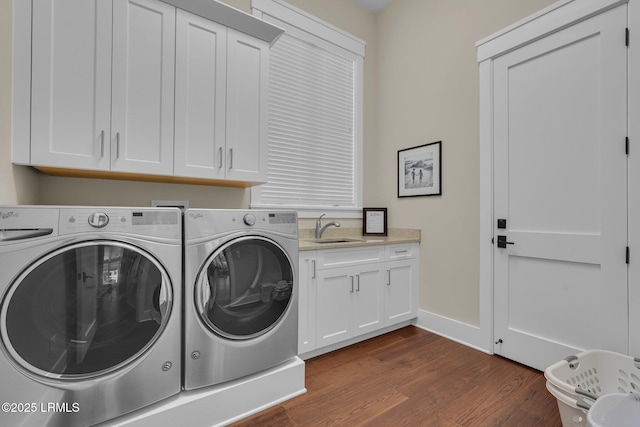 18 Baynard Cove Rd, Hilton Head Island, SC 29928 - washroom with dark wood-type flooring, washer and clothes dryer, a sink, cabinet space, and baseboards