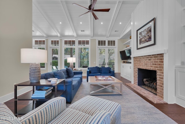 18 Baynard Cove Rd, Hilton Head Island, SC 29928 - living area with built in shelves, wood finished floors, baseboards, ceiling fan, and a brick fireplace
