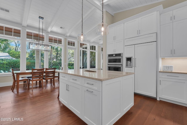 18 Baynard Cove Rd, Hilton Head Island, SC 29928 - kitchen featuring vaulted ceiling with beams, pendant lighting, double oven, white cabinetry, and dark wood-style flooring