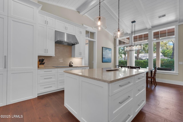 18 Baynard Cove Rd, Hilton Head Island, SC 29928 - kitchen with tasteful backsplash, vaulted ceiling with beams, dark wood-type flooring, and extractor fan