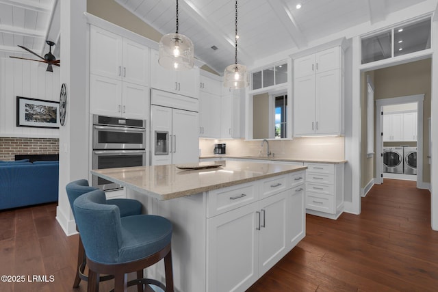 18 Baynard Cove Rd, Hilton Head Island, SC 29928 - kitchen featuring white cabinetry, lofted ceiling with beams, separate washer and dryer, and paneled built in refrigerator