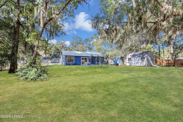 view of yard featuring a shed and a trampoline