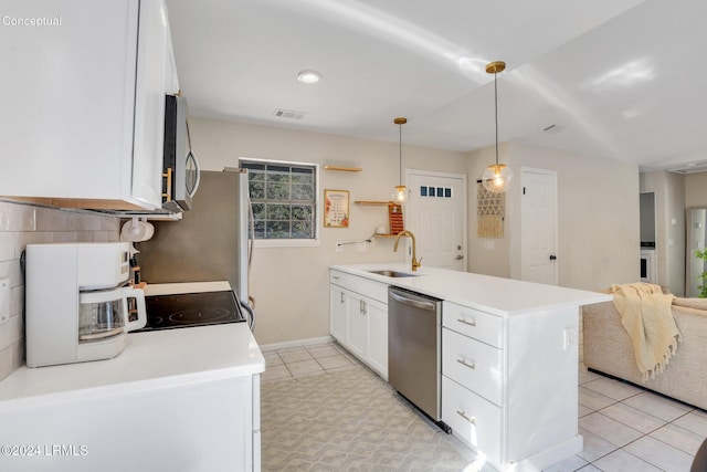 kitchen featuring sink, white cabinetry, hanging light fixtures, light tile patterned floors, and stainless steel appliances