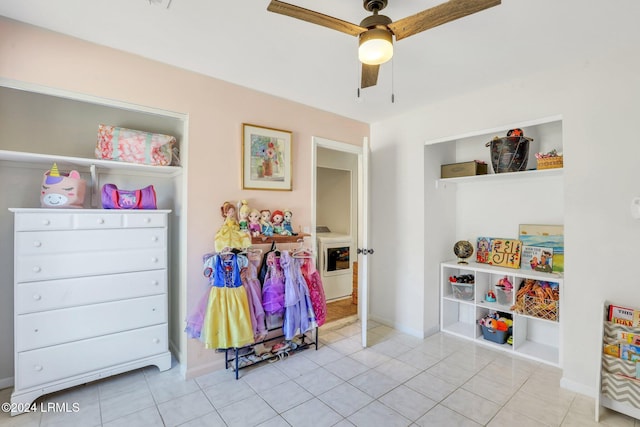 rec room featuring washer / dryer, ceiling fan, and light tile patterned flooring