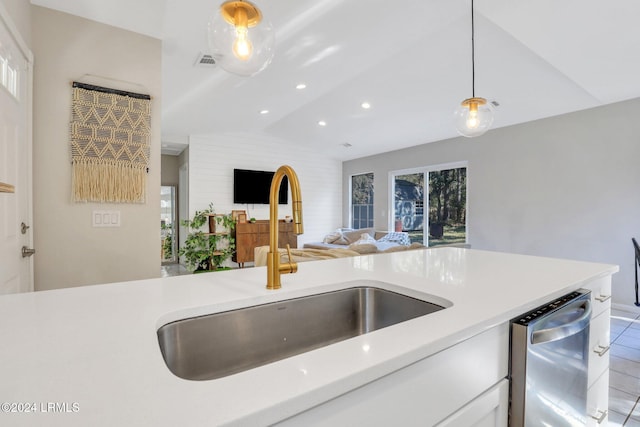 kitchen with hanging light fixtures, a wealth of natural light, sink, and dishwasher