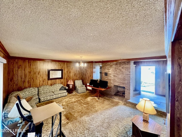 carpeted living room with an inviting chandelier, a fireplace, a textured ceiling, and wood walls