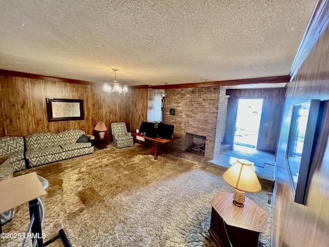 living room with wooden walls, a chandelier, a textured ceiling, and carpet