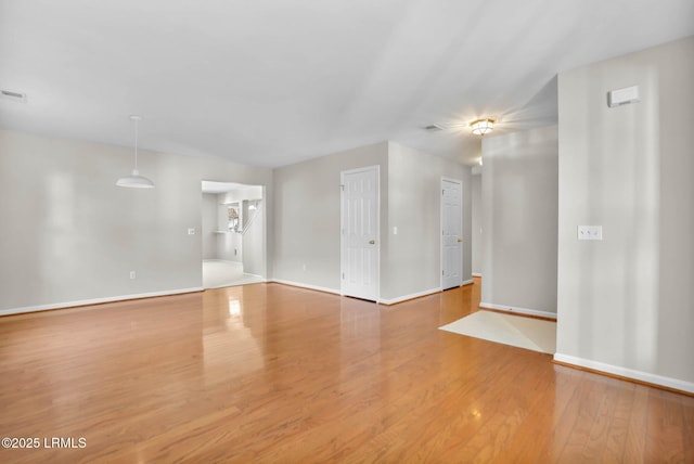 spare room featuring wood-type flooring