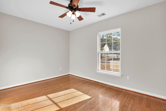 spare room with wood-type flooring and ceiling fan