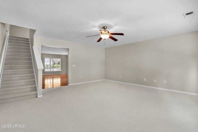 carpeted spare room with ceiling fan