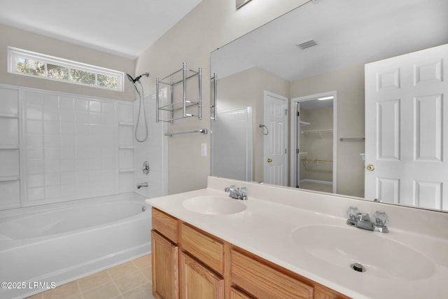 bathroom with vanity, tile patterned flooring, and washtub / shower combination