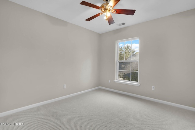 carpeted spare room featuring ceiling fan