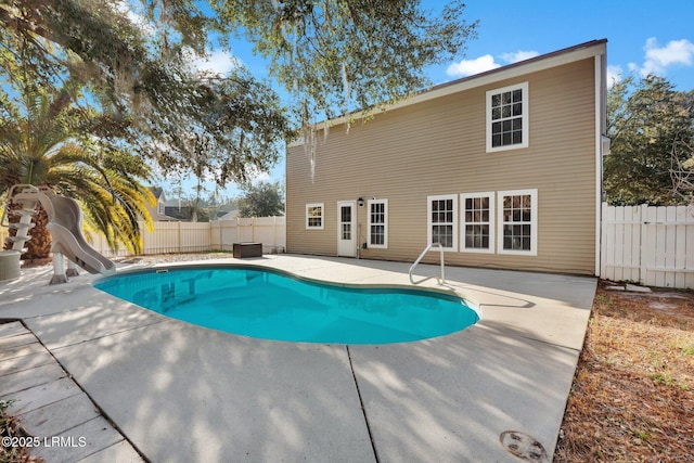 view of swimming pool with a water slide and a patio