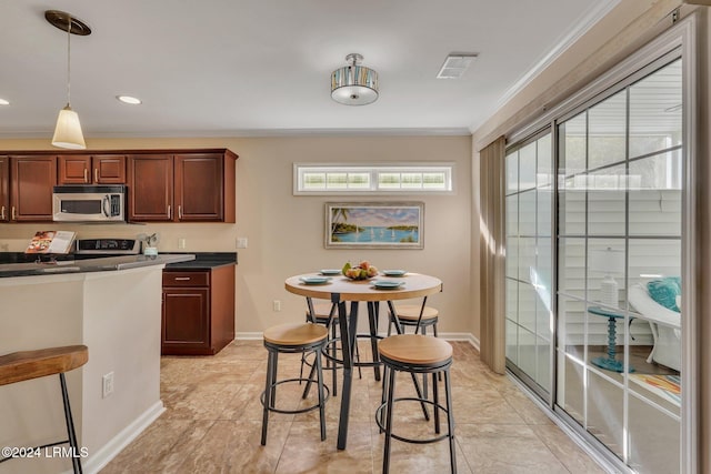 kitchen featuring ornamental molding, hanging light fixtures, and light tile patterned floors