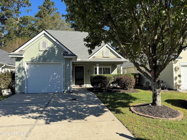 view of front of house featuring a garage and a front yard