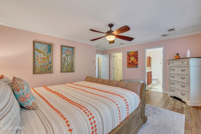 bedroom with crown molding, ceiling fan, ensuite bathroom, and light hardwood / wood-style floors