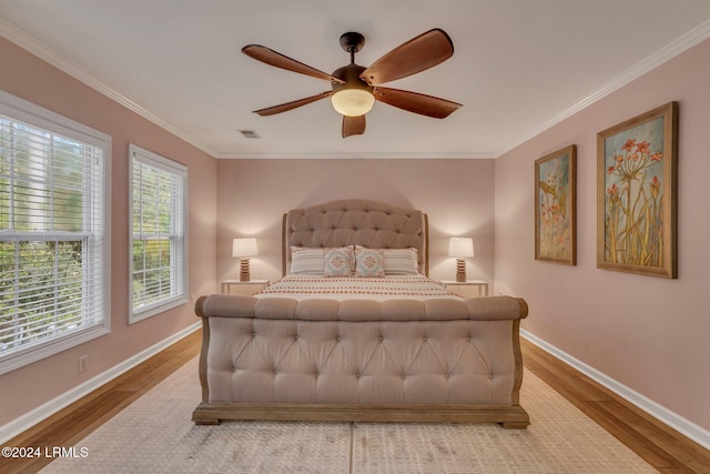 bedroom with crown molding, ceiling fan, and hardwood / wood-style flooring